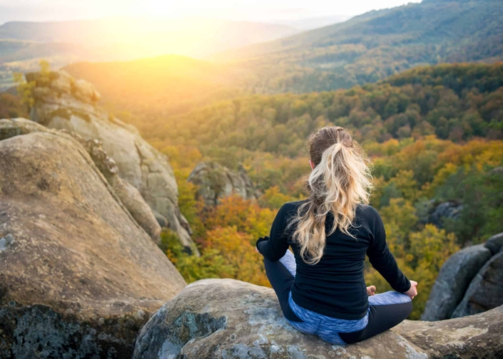 Woman enjoying the sunset in the mountains